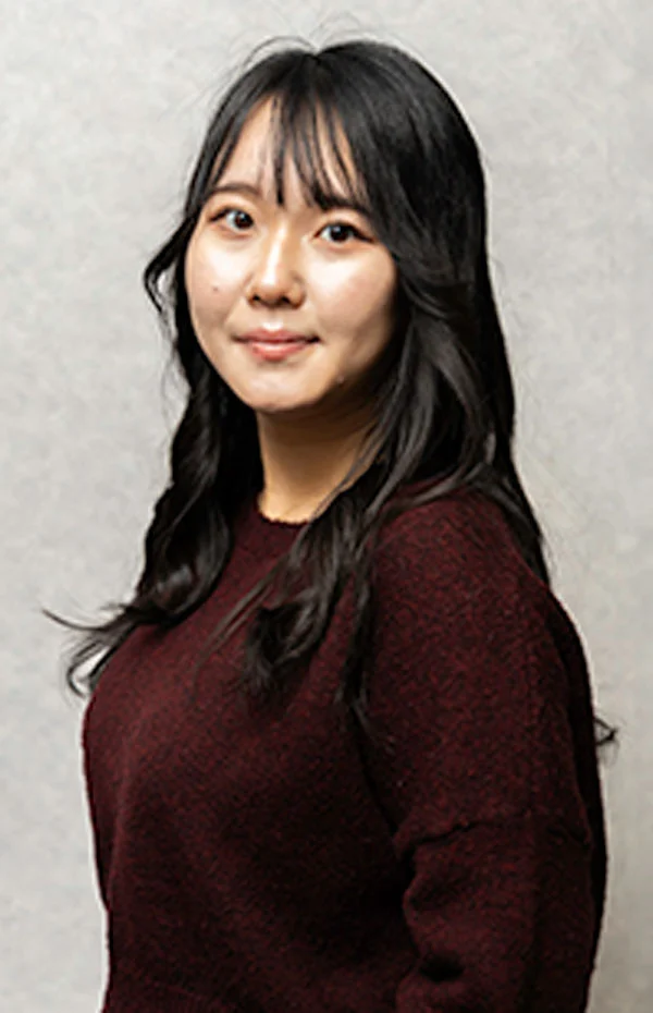Female with long dark hair wearing a red sweater