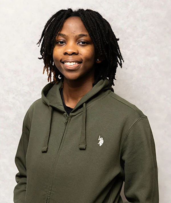Female with dark hair wearing a green hoodie